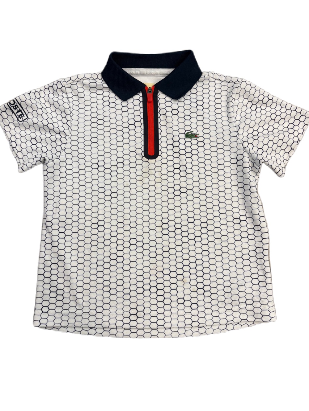 Lacoste White Polo with Navy Hex Pattern and Red Zip - Size 6